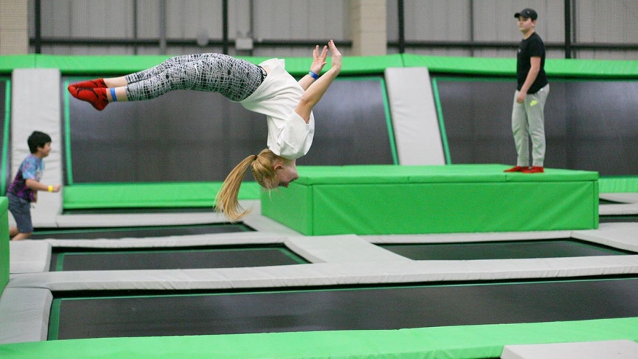 A visitor performing a back flip on a trampoline at AirHop Blackpool.