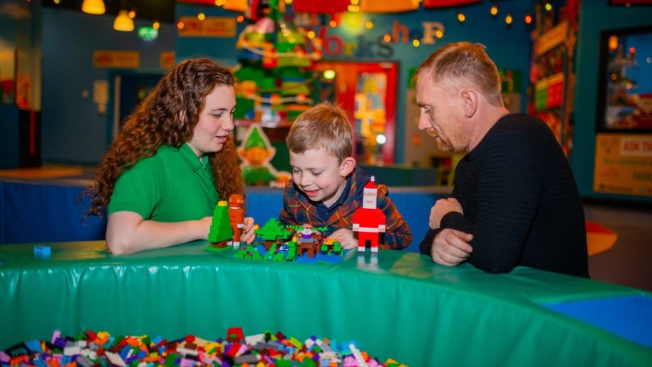 A family building with LEGO bricks.