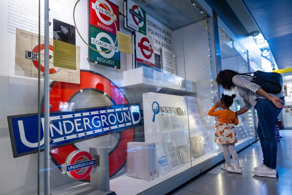 a mum and child look at displays in London Transport Museum