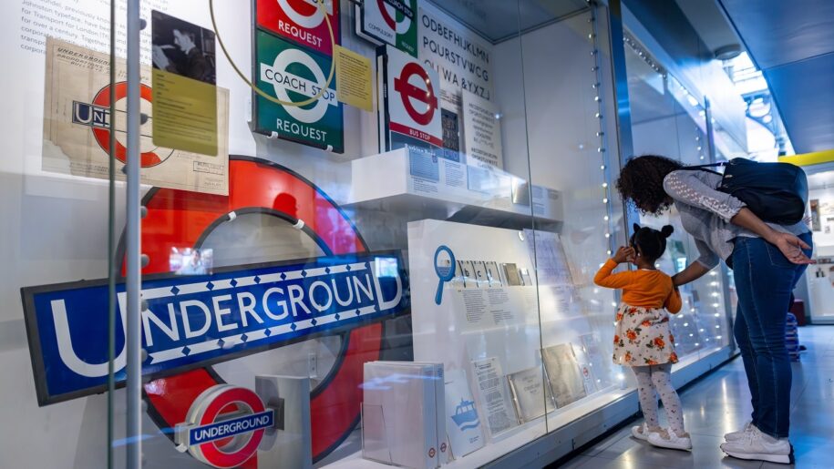 a mum and child look at displays in London Transport Museum