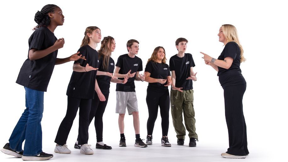 a singing group of young adults in their drama kids tops