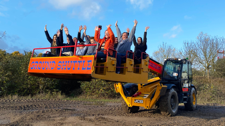 people riding on a digger