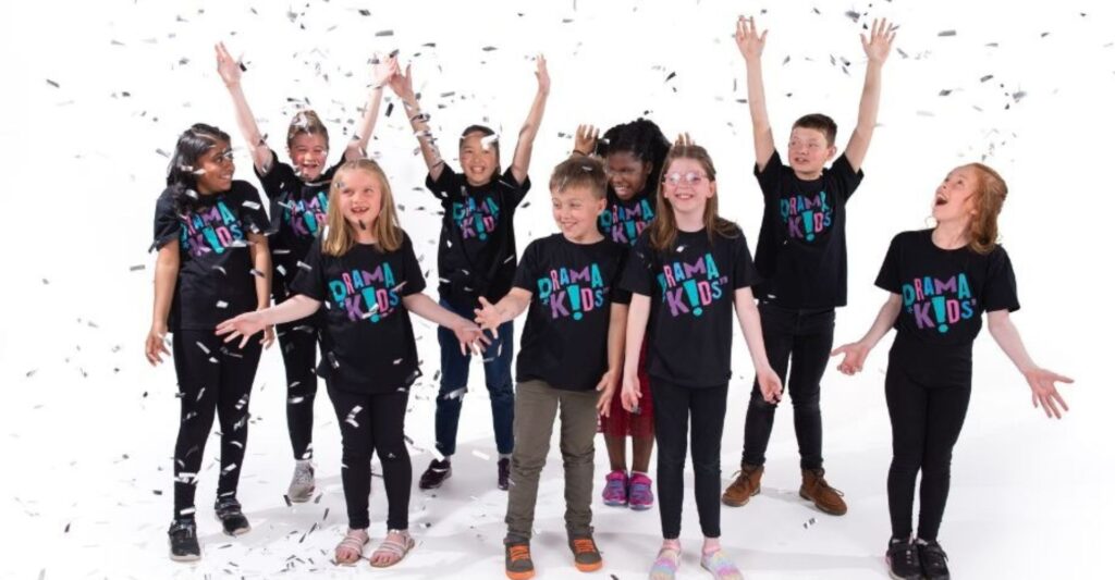 class of children celebrating fun at drama class