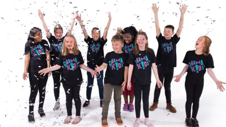 class of children celebrating fun at drama class