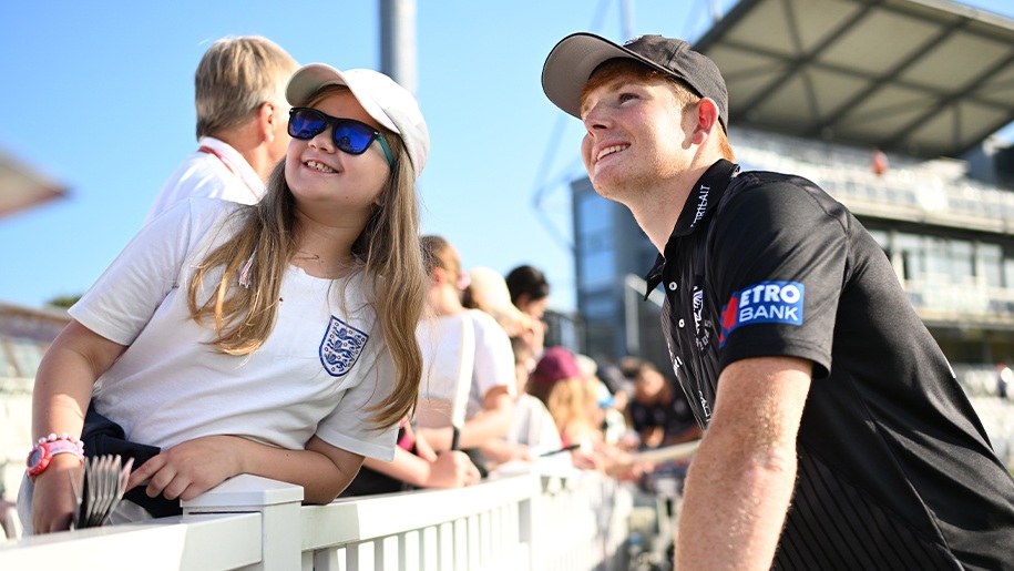 A man and a woman looking up at something at a sports ground.