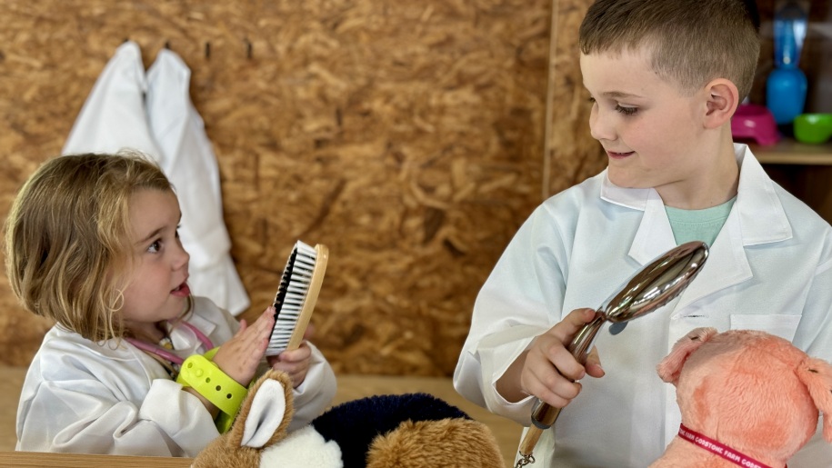 Children role-playing as animal groomers.