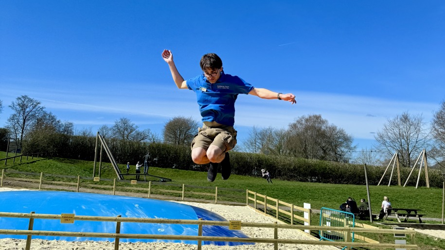Boy bouncing on a jumping pillow.