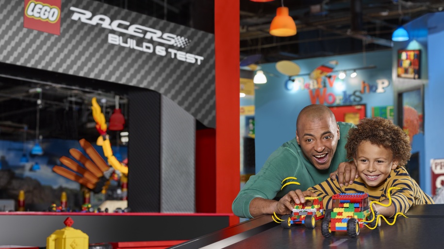 A father and son testing LEGO racers they have built.