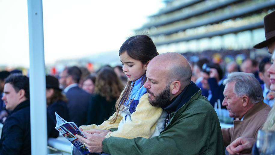 crowd looking at racecard