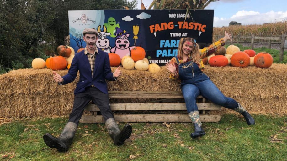 scarecrows dressed up by hay bales