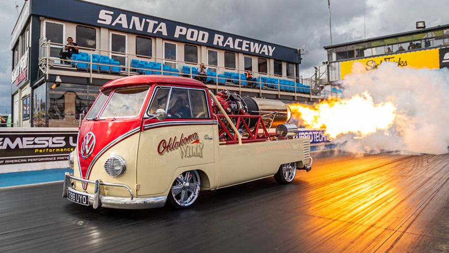 flaming campervan travels on racetrack