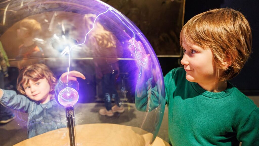 little boy looking at electric ball