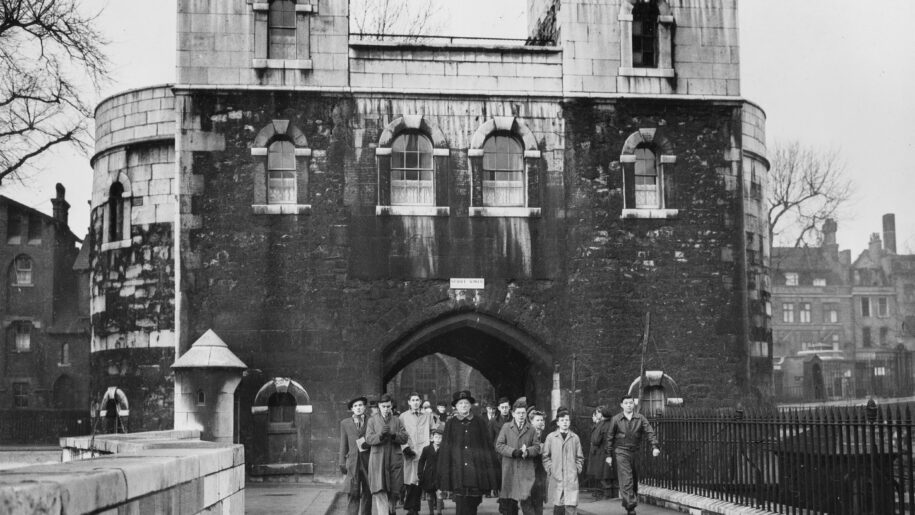 Yeoman Warder Ford leading a group of visitors through the grounds of the Tower of London on the first day the site was reopened after the Second War World