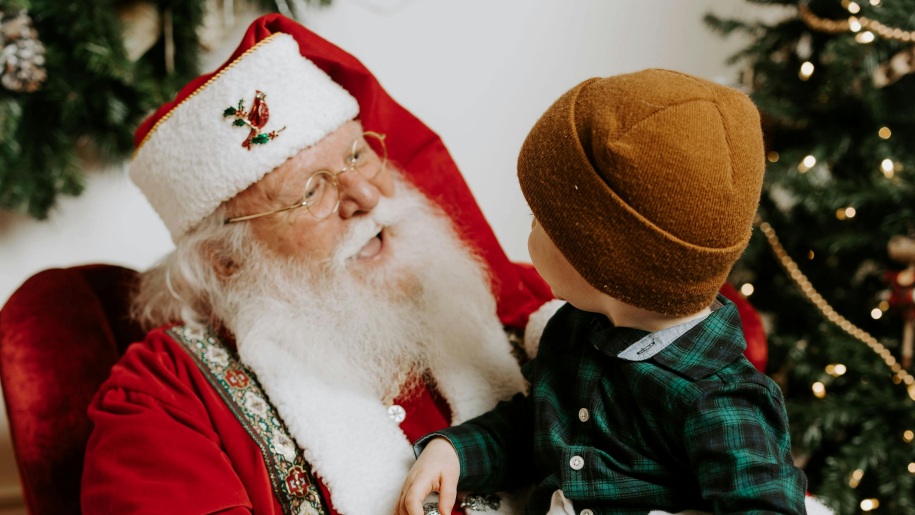 Santa Claus talking to a child.