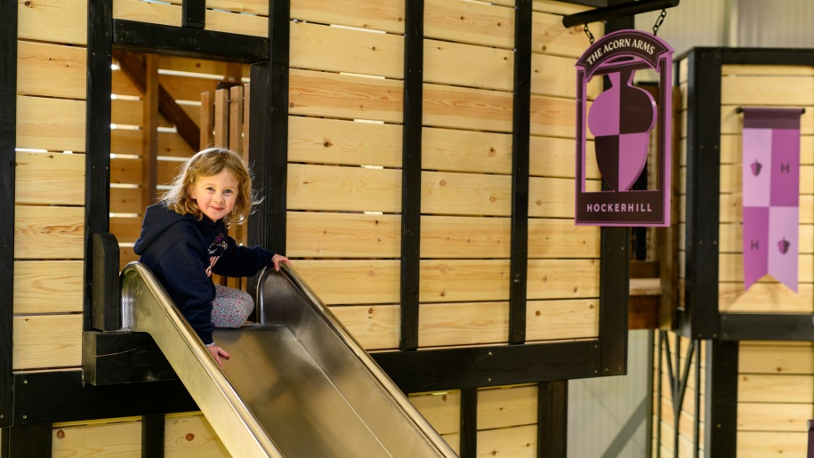 Young girl going down a slide.