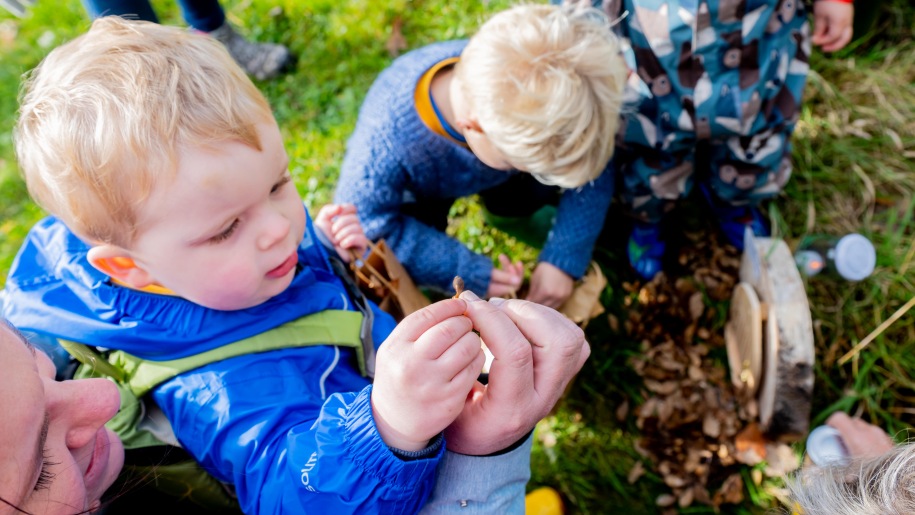 Young children on an autumn scavenger hunt.