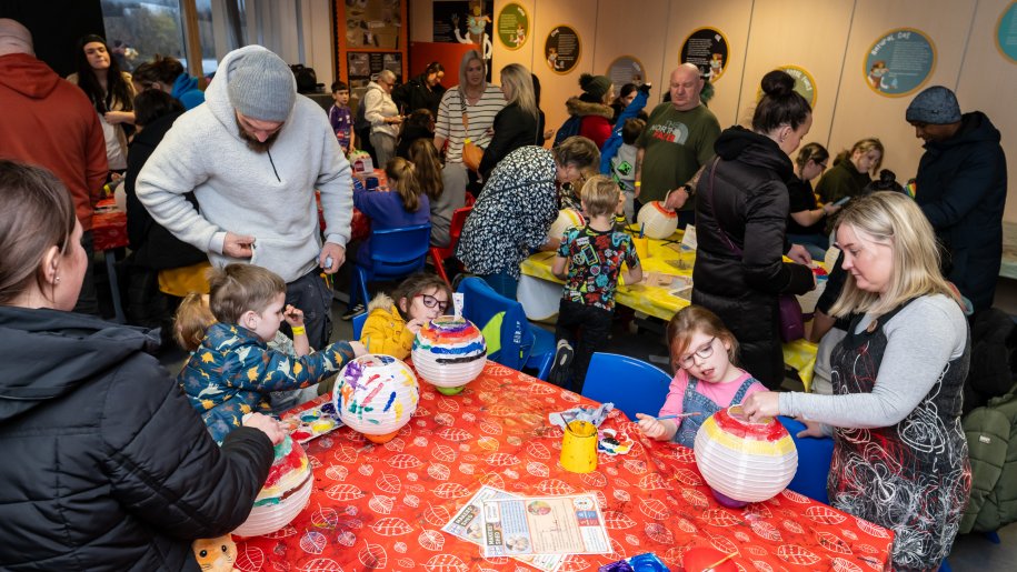 Families making Christmas lanterns.