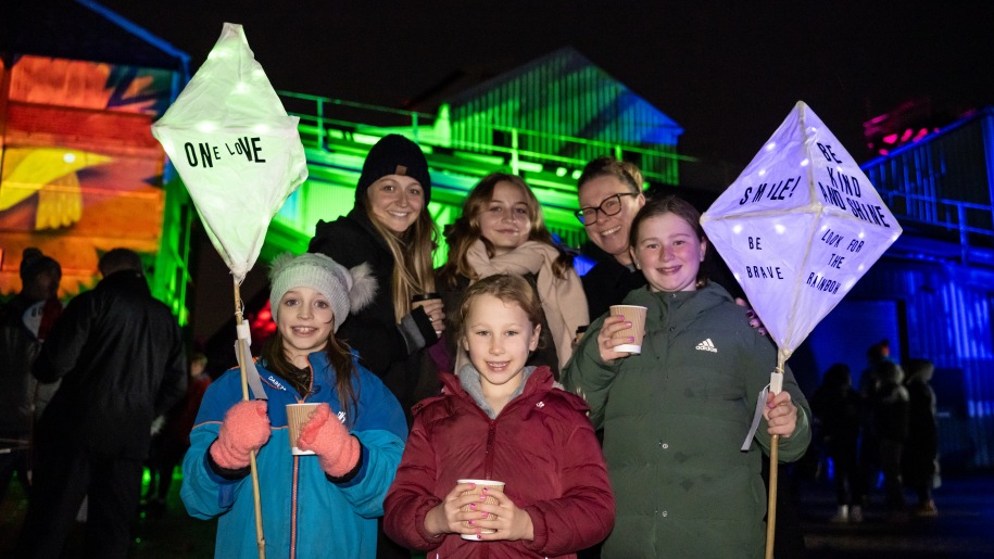 Family with lanterns for lantern parade.