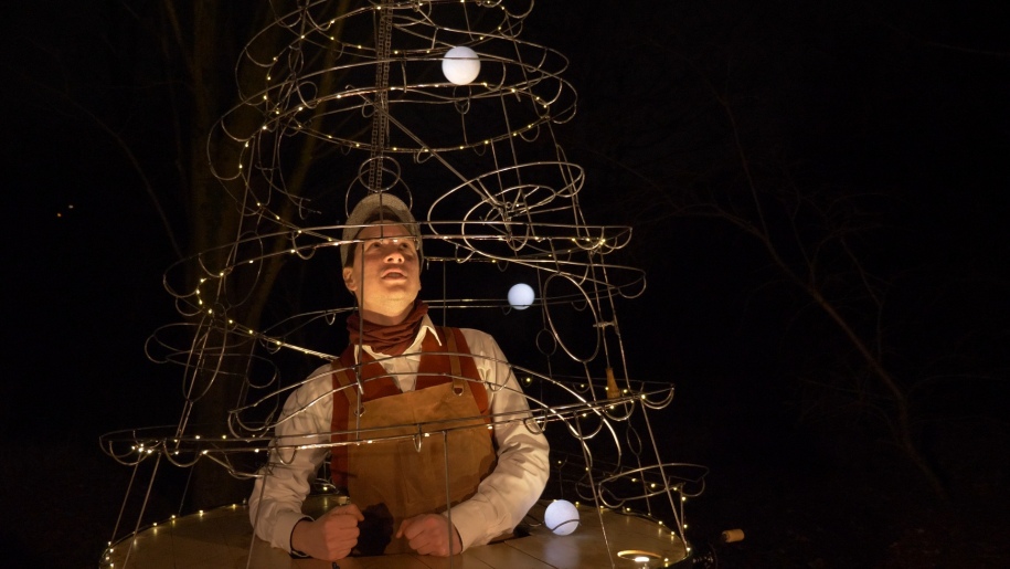Street theatre performer with an interactive sculpture of a Christmas tree.