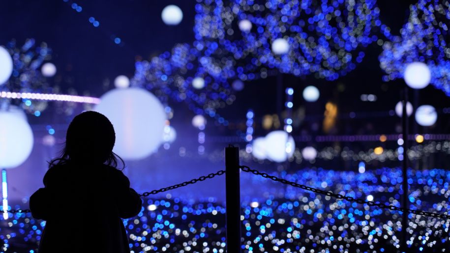 little girl looks at blue lights