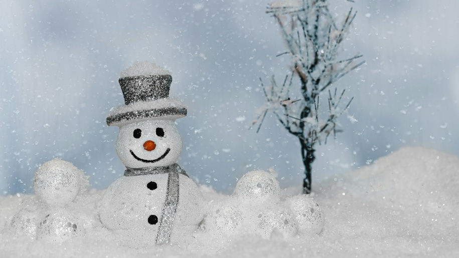 Christmas snowman decoration in a sparkling frosty winter scene.