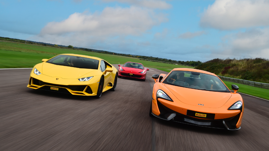 orange and yellow racecars on track