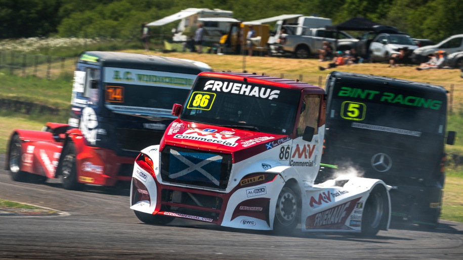 Trucks racing on a circuit.