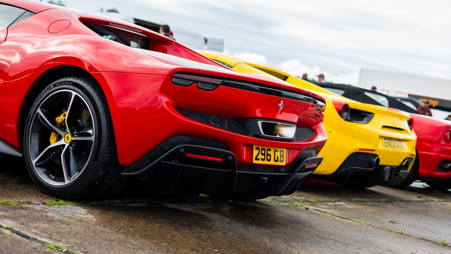 Red and yellow cars parked in a row.