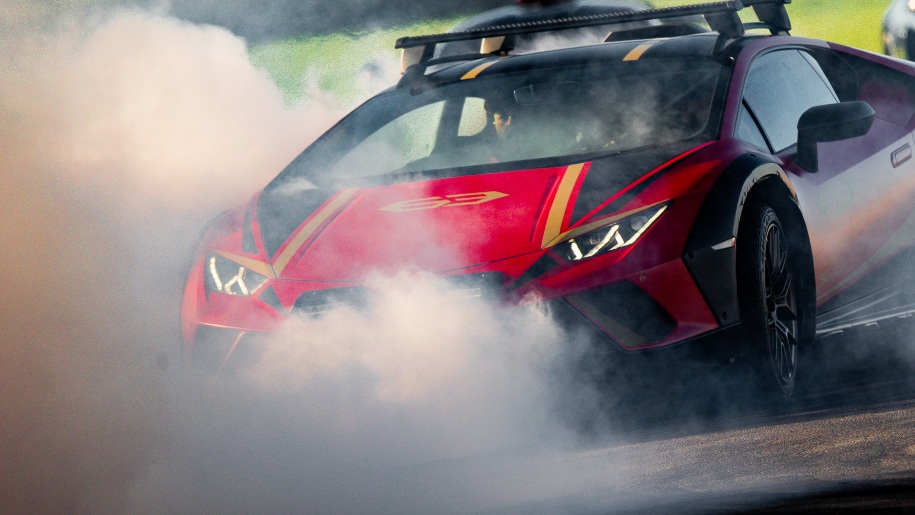 Red supercar on a race circuit.
