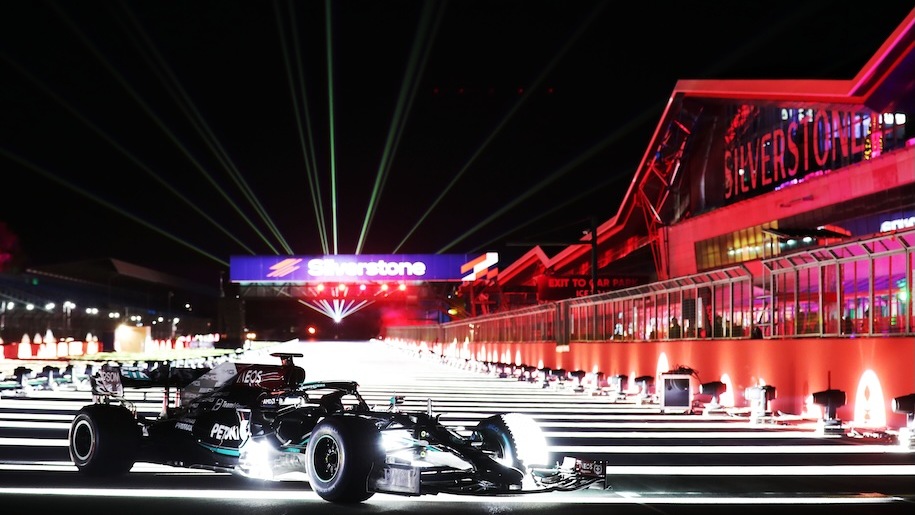 Racing car on Silverstone Circuit lit up by Christmas lights.