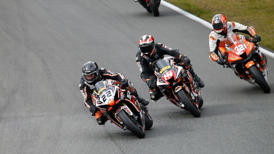 Motorcycles racing on a circuit.