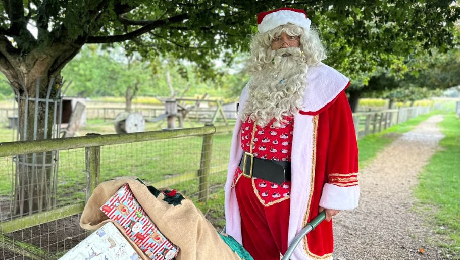 father christmas taking round presents in a wheelbarrow