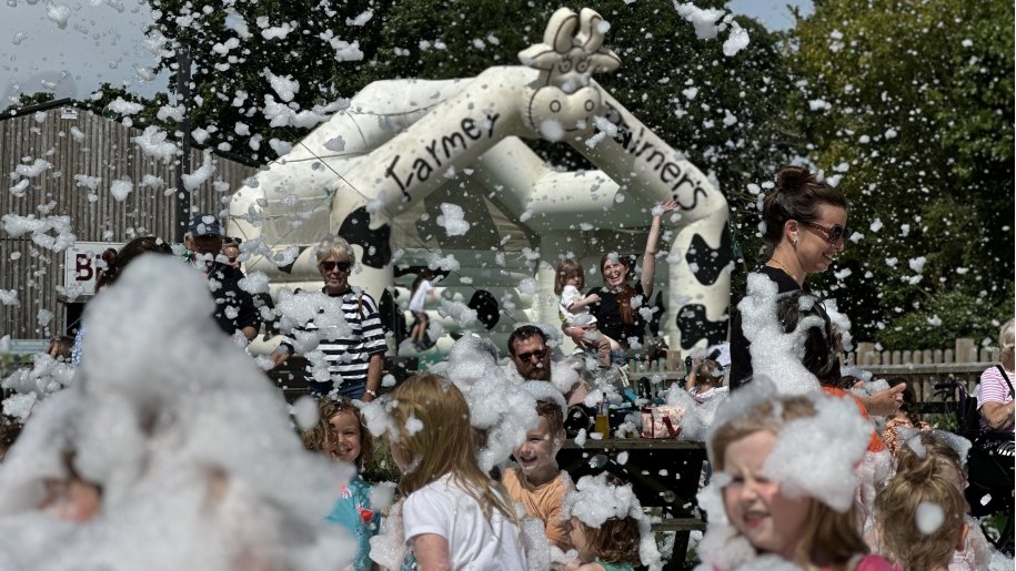 Visitors enjoying the foam party at Farmer Palmer's Farm Park.