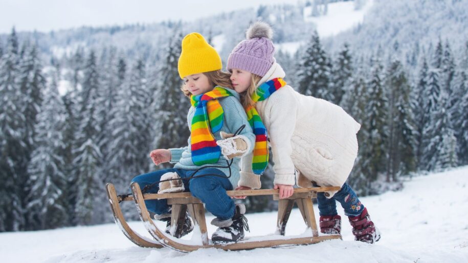 girls play on sled