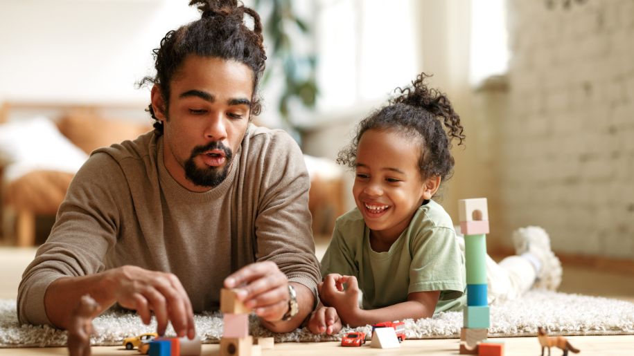 man and boy playing lego