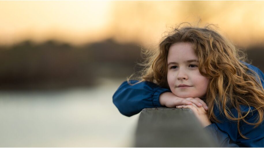 girl looks out over lake