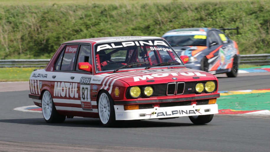 Cars racing on the track at Thruxton Circuit.