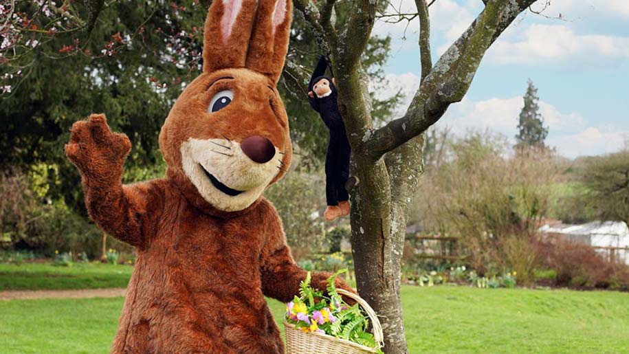 bron easter bunny holding a wicker basket of easter eggs