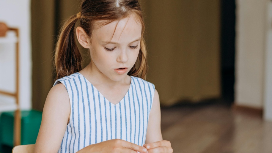 Young girl engaged in craft activities.