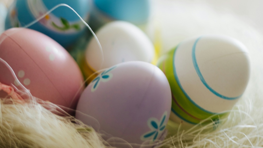 Easter eggs painted in pastel designs in a nest.