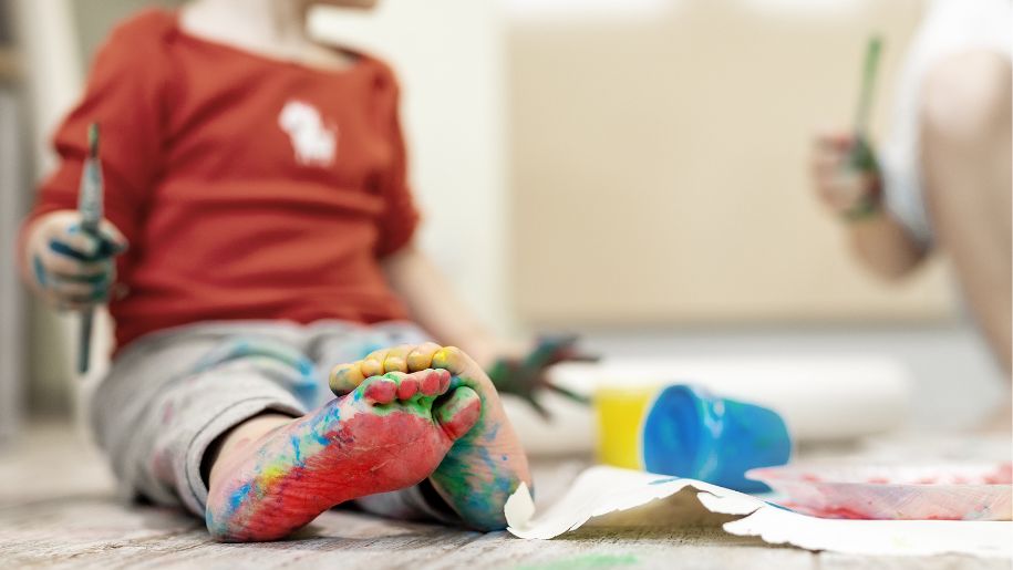 red paint on a boys foot