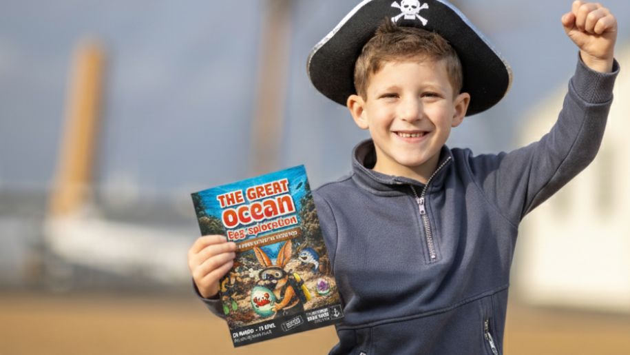 boy in a pirate hat with a leaflet for event