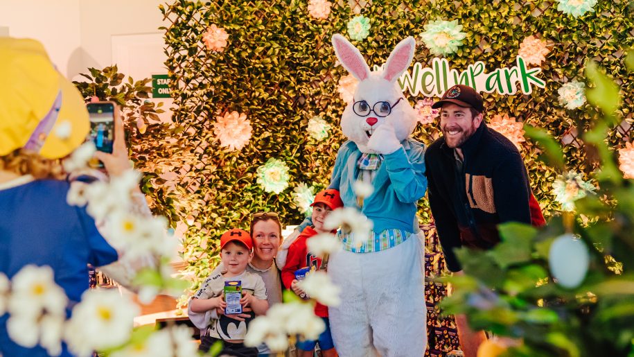 The Easter Bunny posing for a photo with a family of four at Welly Park.