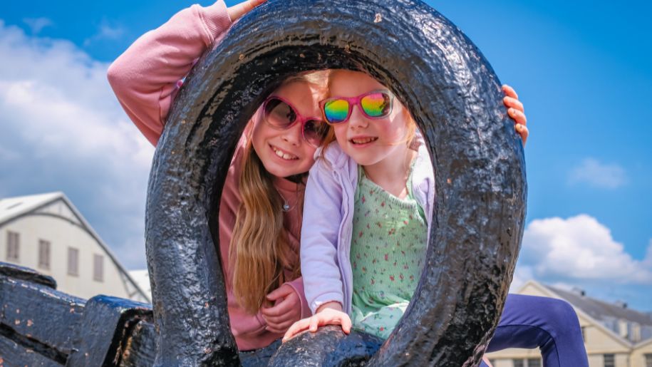 two young girls look through anchor with sunglasses on
