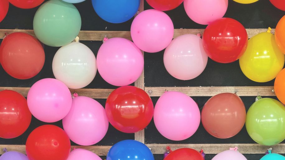 multicoloured balloons attached to a wall