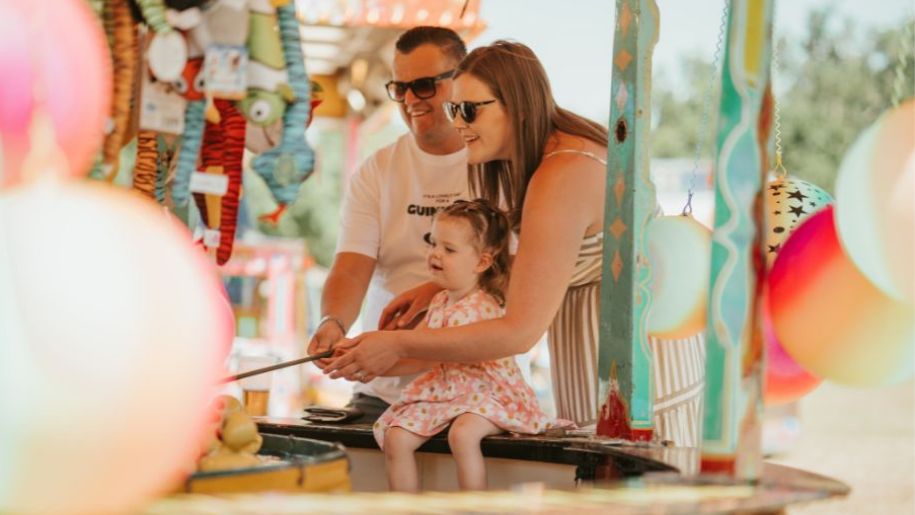 family play hook a duck at a fair