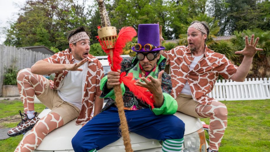 people dressed as giraffes and a magician