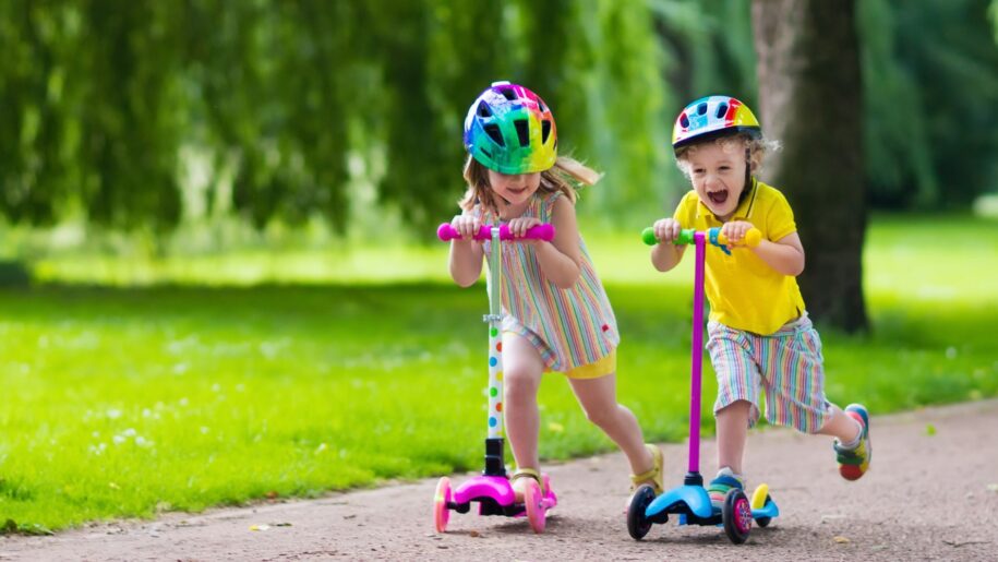 girl and boy race on scooters