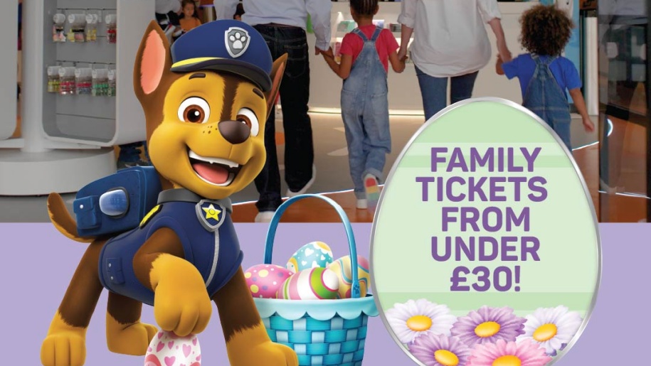 Children's PAW Patrol character mascot beside a basket of Easter eggs.