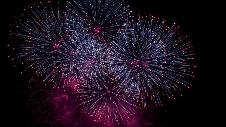 Fireworks exploding in the night sky.